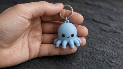 Octopus keychain held in an open hand to show its roughly 3 cm size (AI-generated preview)